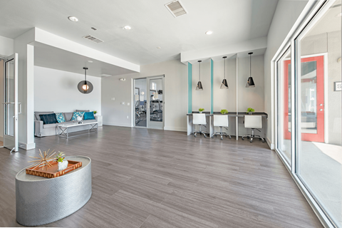 a resident clubhouse with gray flooring and white walls  at Collective on Riverside, Austin